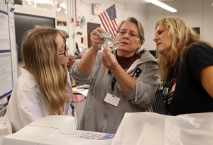 Collins Sheldon, (left), Dee Reedy (middle), and Lisa Fontaine-Dorsey (right) examine lab materials in the science lab at North Marion High School in Ocala, FL.