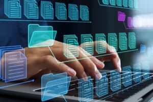 hands typing on keyboard with images of documents and files superimposed